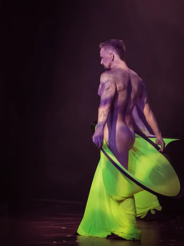 Male performer with neon yellow hoop fabric
